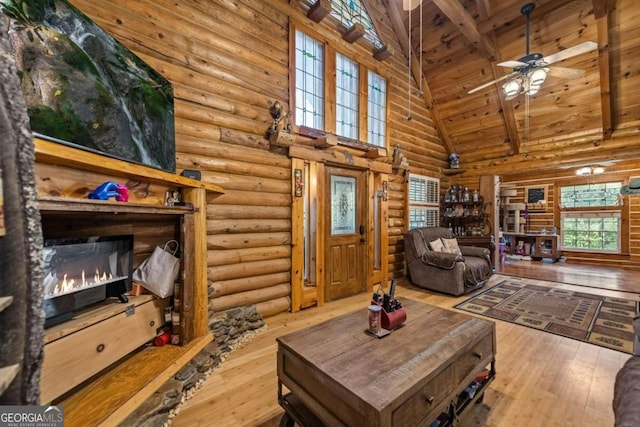 living room featuring beam ceiling, high vaulted ceiling, hardwood / wood-style floors, ceiling fan, and wooden ceiling