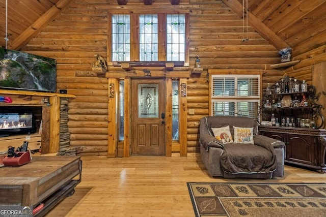 interior space featuring light wood-type flooring, a healthy amount of sunlight, and log walls