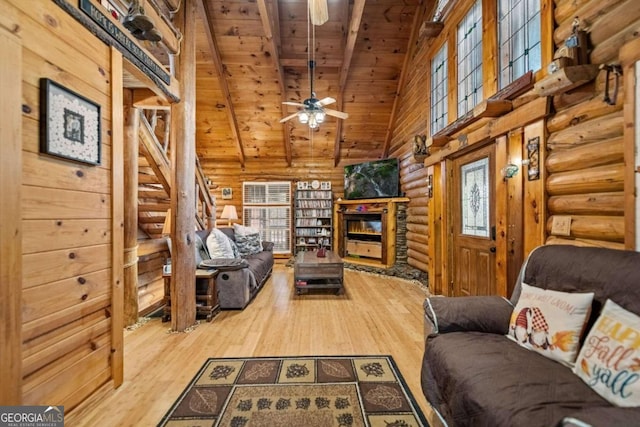 living room with wood ceiling, vaulted ceiling with beams, ceiling fan, and hardwood / wood-style flooring