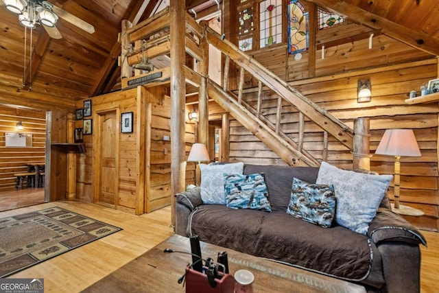 living room with wood ceiling, beam ceiling, high vaulted ceiling, and hardwood / wood-style floors