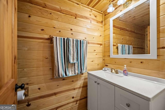 bathroom featuring wood ceiling, wooden walls, and vanity