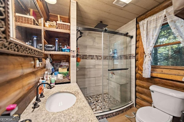 bathroom with wood walls, a shower with door, toilet, and sink