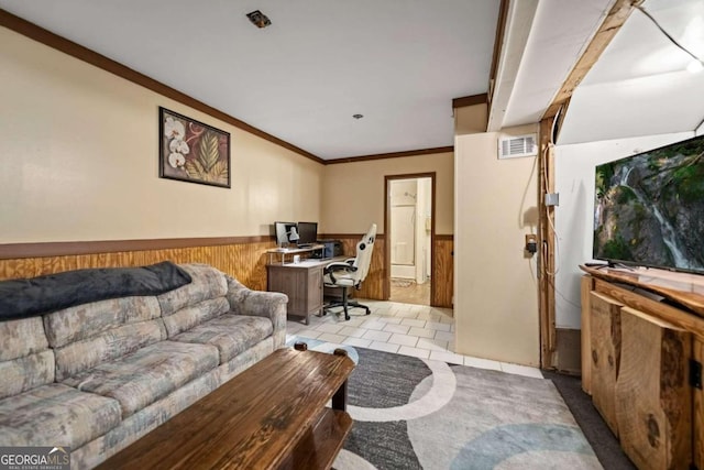 living room with crown molding, wooden walls, and light tile patterned floors