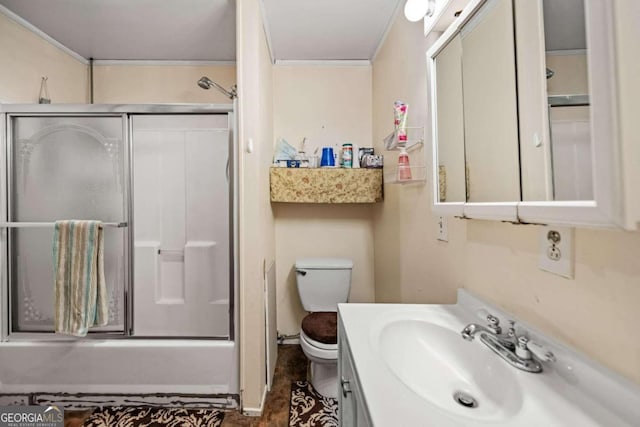 full bathroom featuring bath / shower combo with glass door, vanity, and toilet