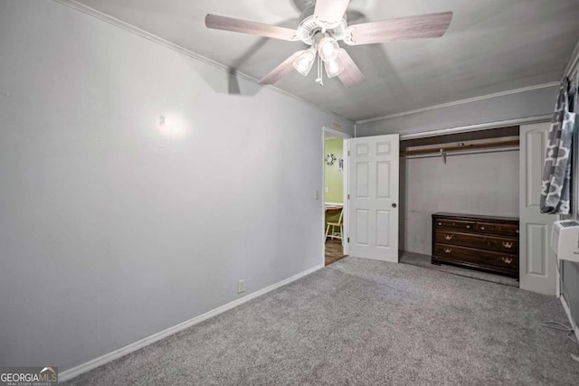 unfurnished bedroom with carpet, crown molding, ceiling fan, and a closet