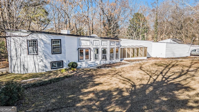 back of property with a sunroom