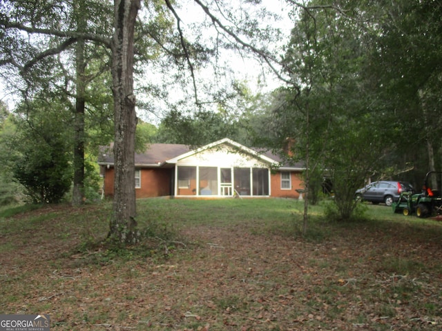 back of property with a sunroom