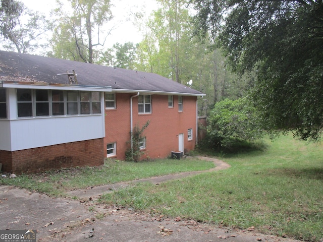 view of side of home featuring a yard