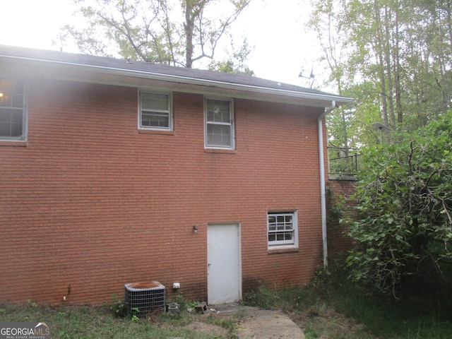 rear view of property with central air condition unit