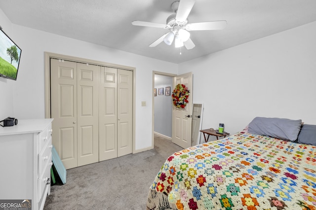 bedroom with ceiling fan, light colored carpet, and a closet