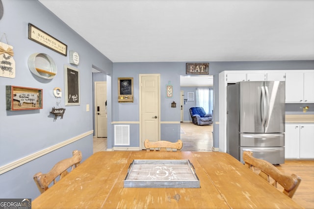 dining space featuring light wood-type flooring