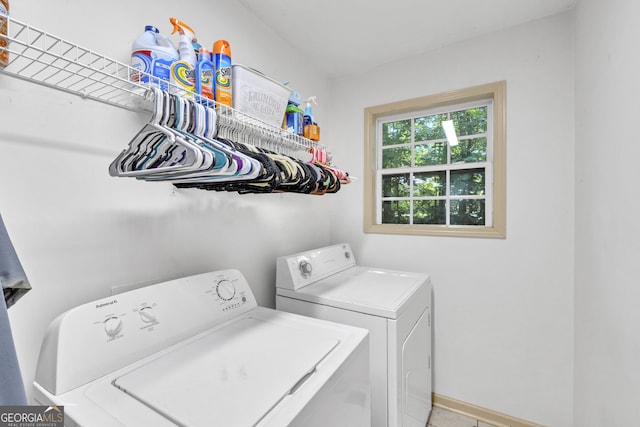 washroom with light tile patterned floors and washer and clothes dryer