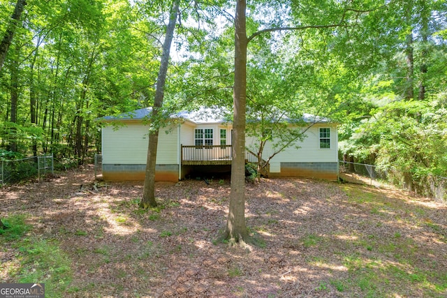 rear view of property with a wooden deck