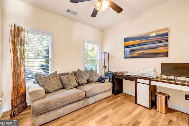 office area with ceiling fan, light hardwood / wood-style floors, and a healthy amount of sunlight