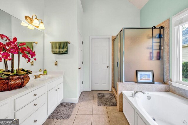 bathroom with a wealth of natural light, vanity, and independent shower and bath