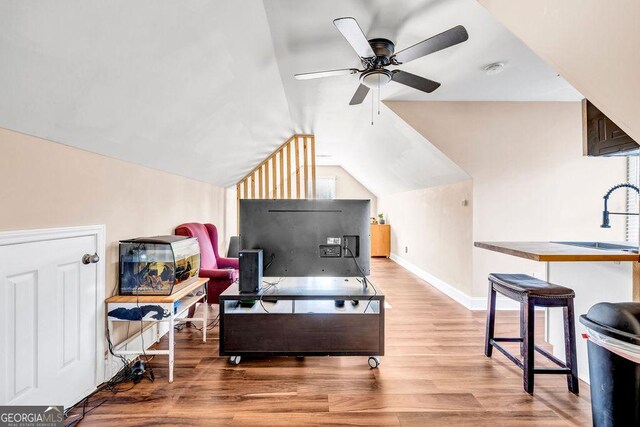 interior space with vaulted ceiling, sink, light wood-type flooring, and ceiling fan