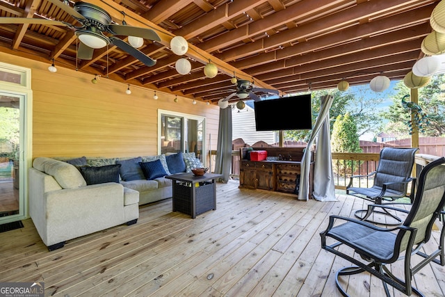 deck with an outdoor living space and ceiling fan