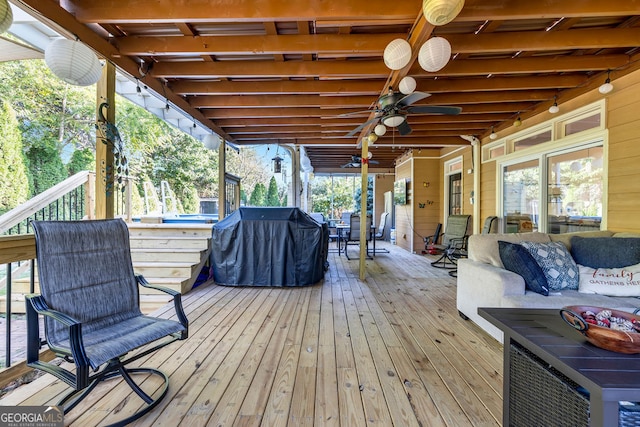 deck featuring an outdoor hangout area, ceiling fan, and grilling area