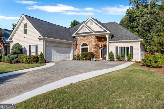 view of front of property featuring a front yard and a garage