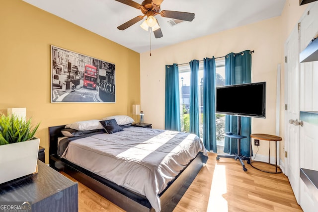 bedroom featuring ceiling fan and light hardwood / wood-style flooring