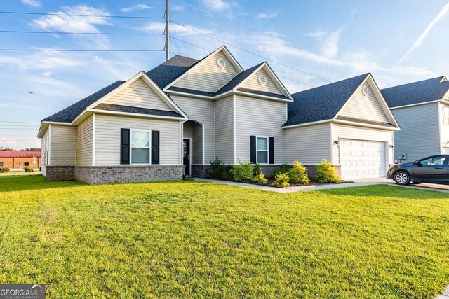 front facade featuring a garage and a front lawn