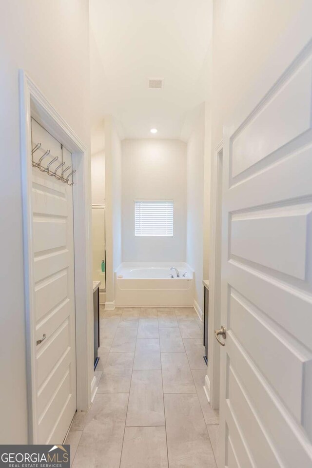 hall featuring light tile patterned flooring