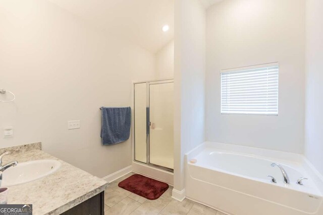 bathroom featuring vanity, plus walk in shower, and vaulted ceiling