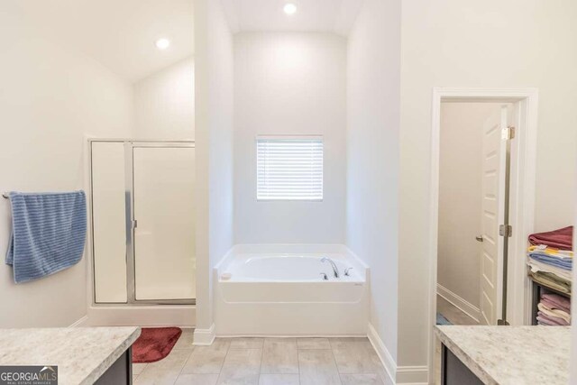 bathroom with vanity, plus walk in shower, and vaulted ceiling