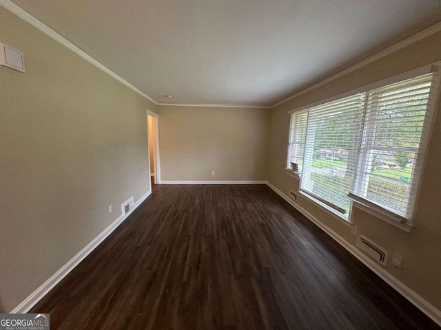 unfurnished room featuring crown molding, dark wood-type flooring, and a healthy amount of sunlight