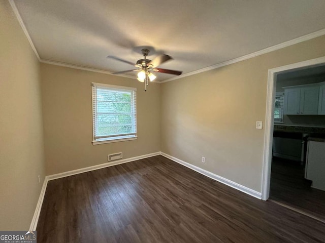 unfurnished room featuring ceiling fan, crown molding, and dark hardwood / wood-style flooring