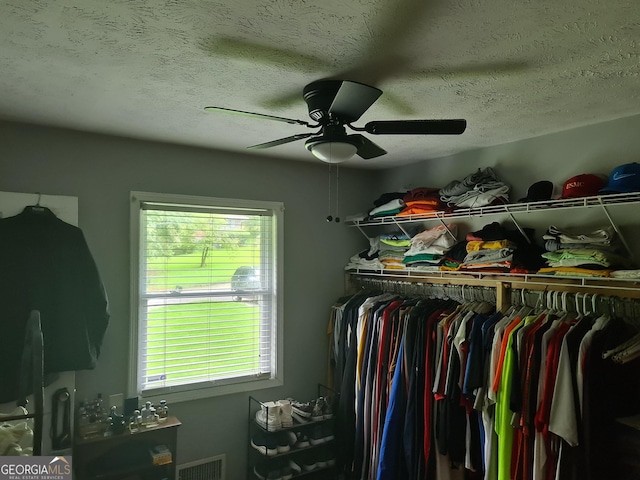 spacious closet with ceiling fan