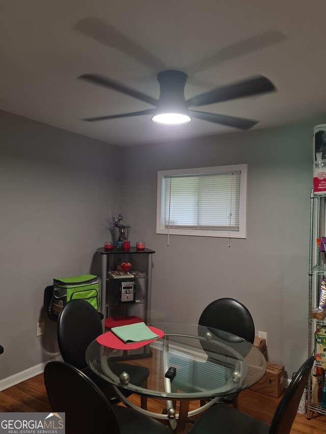 dining area with hardwood / wood-style flooring and ceiling fan