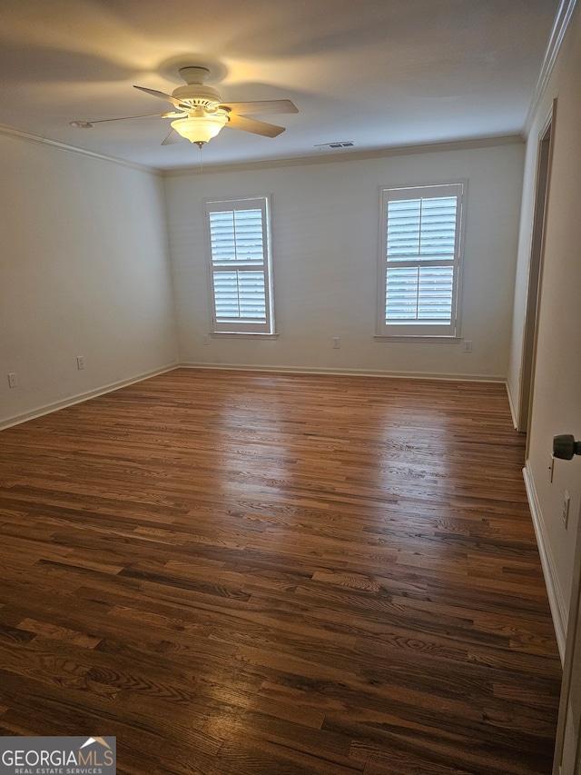 spare room featuring ornamental molding, ceiling fan, and dark hardwood / wood-style floors