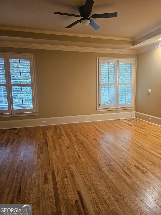 spare room with wood-type flooring, crown molding, and ceiling fan