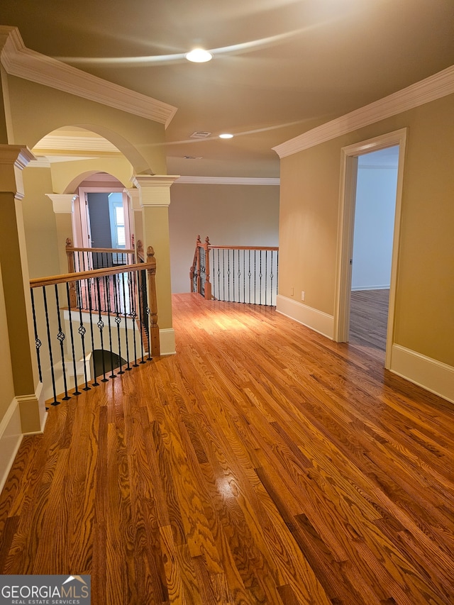 unfurnished room featuring hardwood / wood-style flooring and crown molding