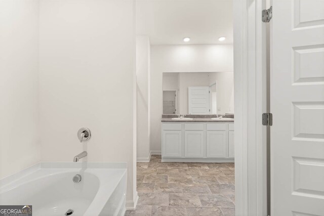 bathroom featuring vanity and a bathtub