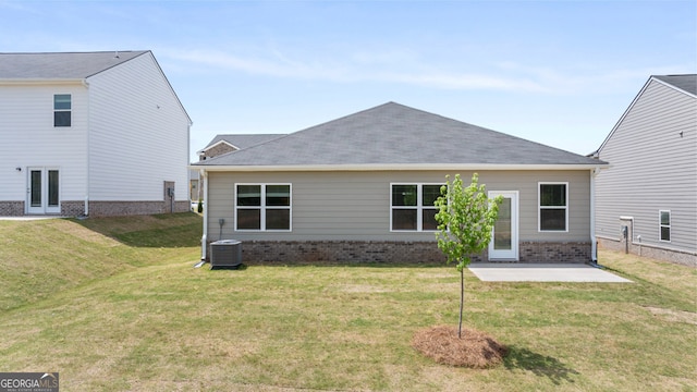 back of property with cooling unit, a yard, and a patio area