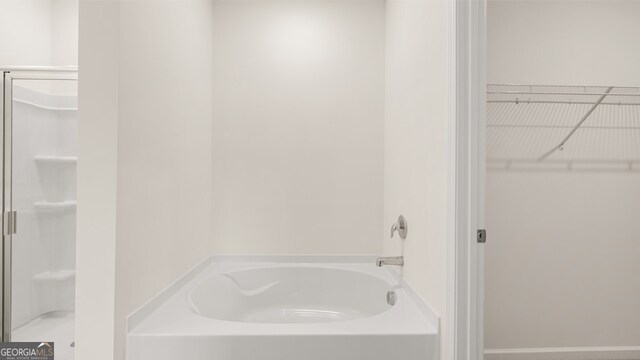 bathroom with shower with separate bathtub