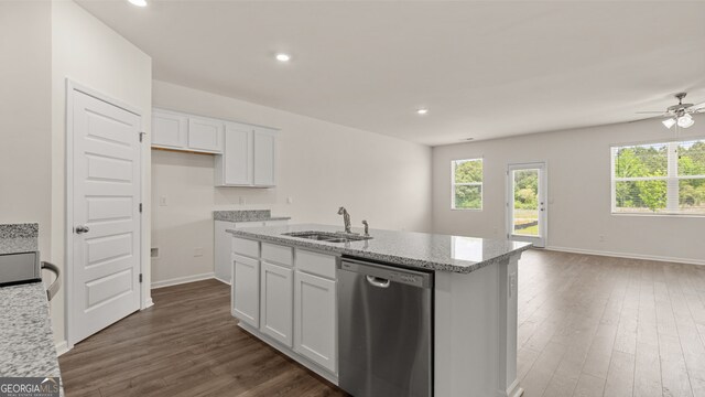 kitchen featuring an island with sink, dishwasher, sink, and white cabinetry