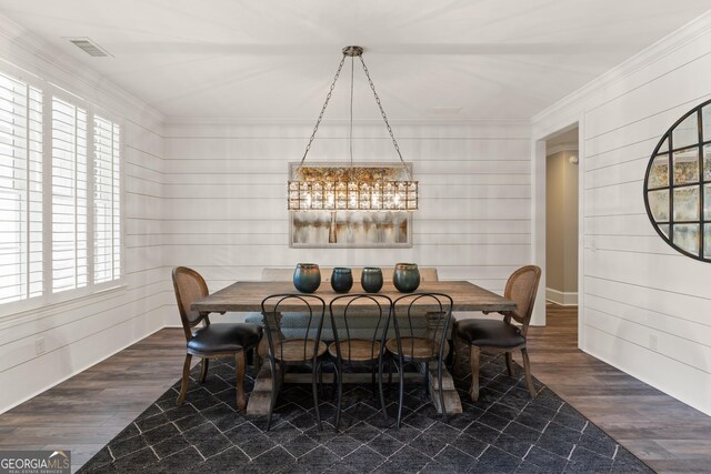 dining space with ornamental molding and dark wood-type flooring