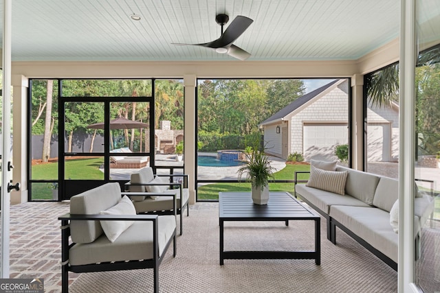 sunroom featuring ceiling fan