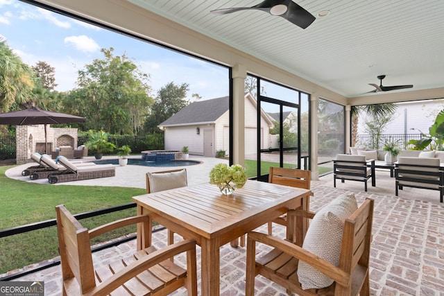 sunroom featuring a ceiling fan