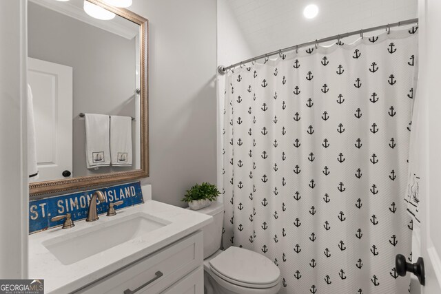 bathroom with vanity, toilet, and curtained shower