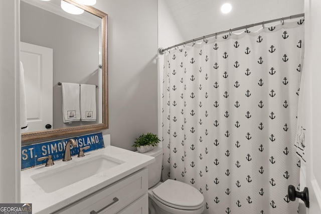 bathroom featuring curtained shower, toilet, and vanity