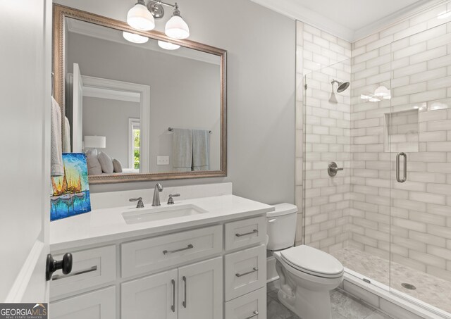 bathroom with toilet, ornamental molding, vanity, and walk in shower