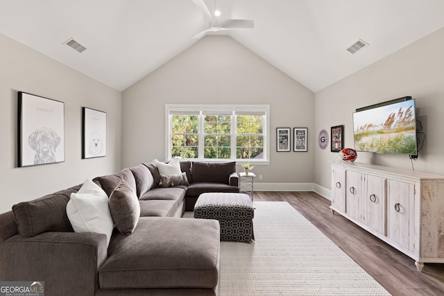 living room featuring dark hardwood / wood-style flooring and high vaulted ceiling