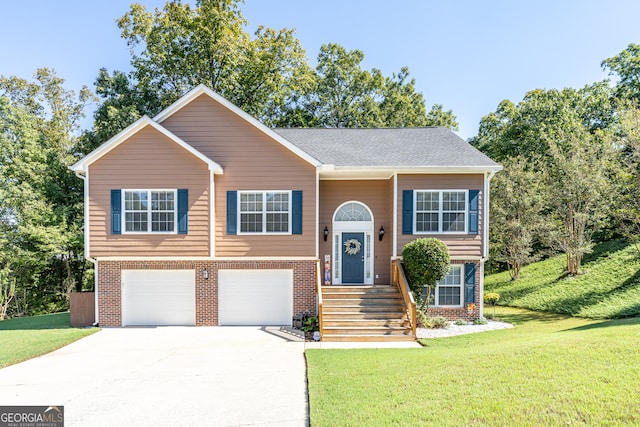 bi-level home with a garage and a front yard