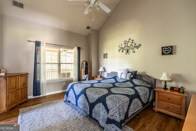 bedroom featuring dark wood-type flooring, ceiling fan, and high vaulted ceiling