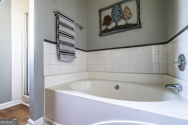 bathroom featuring hardwood / wood-style floors and a bathtub