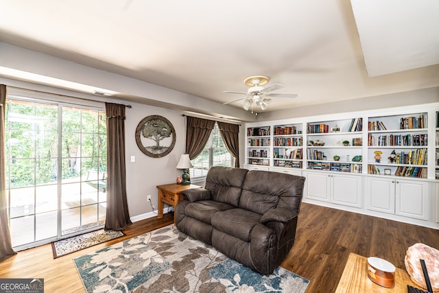 living room with ceiling fan, dark hardwood / wood-style floors, and a healthy amount of sunlight